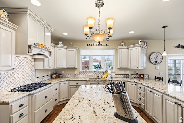 kitchen featuring white cabinetry, plenty of natural light, and pendant lighting