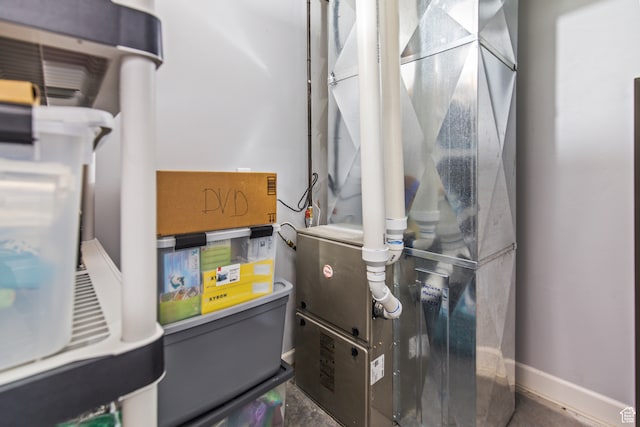 utility room featuring heating unit