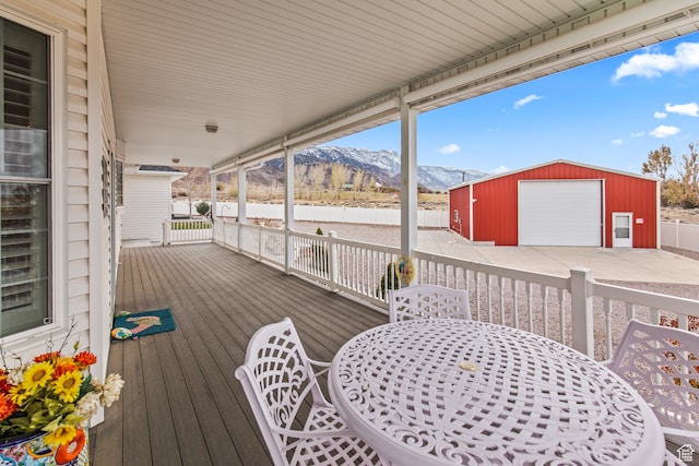wooden terrace with a mountain view, an outbuilding, and a garage