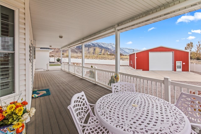 528 E 700 S Unit 4, Monroe, UT 84754 - wooden deck with a mountain view, an outbuilding, outdoor dining area, and a garage