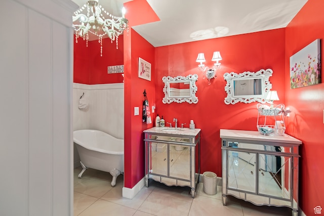bathroom with tile patterned flooring, vanity, a notable chandelier, and a washtub