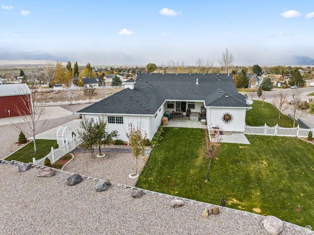 rear view of house featuring a patio area and a yard