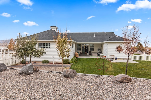 back of house featuring a patio area and a yard