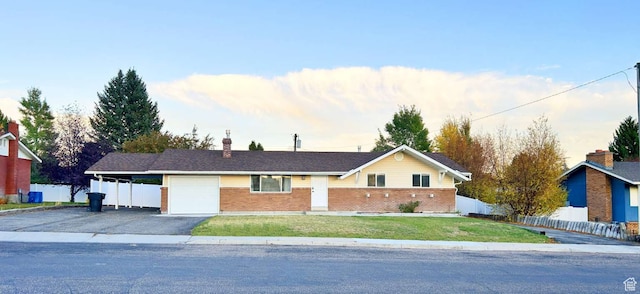 single story home featuring a front lawn and a garage