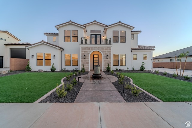 3092 E 2110th St S, St George, UT 84790 - view of front of home with a balcony, a tile roof, a front yard, and stucco siding