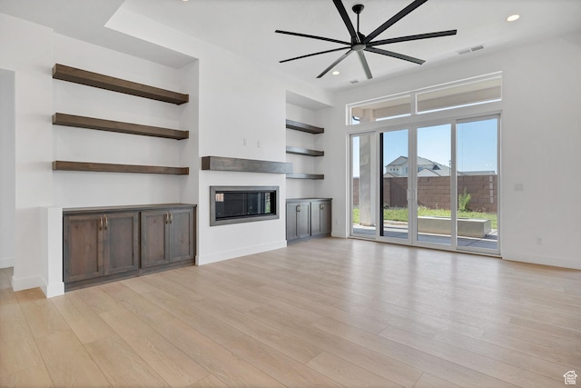 3092 E 2110th St S, St George, UT 84790 - unfurnished living room featuring a glass covered fireplace, light wood finished floors, a ceiling fan, and recessed lighting