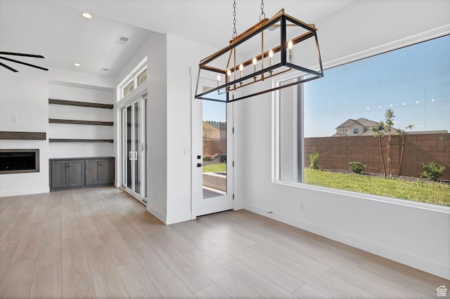 3092 E 2110th St S, St George, UT 84790 - unfurnished dining area featuring wood finished floors, a fireplace, a chandelier, and recessed lighting