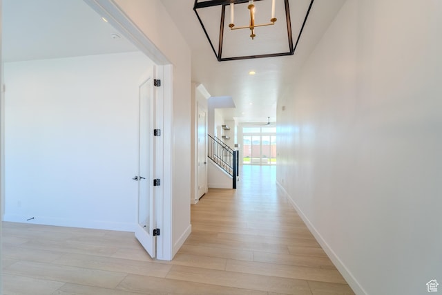 3092 E 2110th St S, St George, UT 84790 - corridor featuring light wood-style flooring, a chandelier, baseboards, and stairs