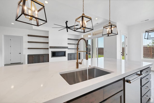 3092 E 2110th St S, St George, UT 84790 - kitchen with a chandelier, recessed lighting, decorative light fixtures, a glass covered fireplace, and open floor plan