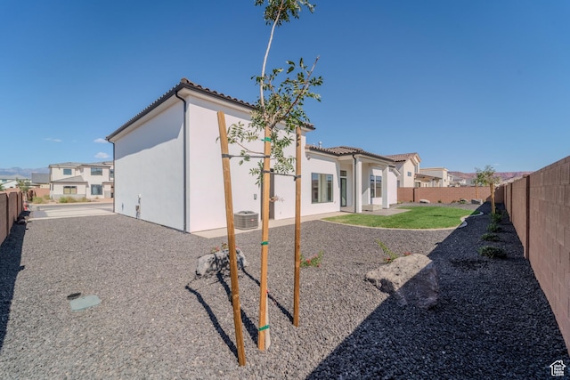 3092 E 2110th St S, St George, UT 84790 - rear view of house featuring a fenced backyard, a tile roof, a patio area, and stucco siding