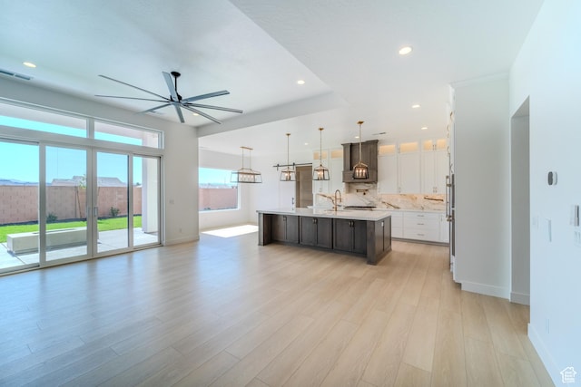 3092 E 2110th St S, St George, UT 84790 - kitchen with open floor plan, ceiling fan, light countertops, a center island with sink, and premium range hood