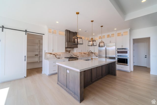 3092 E 2110th St S, St George, UT 84790 - kitchen featuring stainless steel appliances, a sink, a barn door, light countertops, and white cabinets