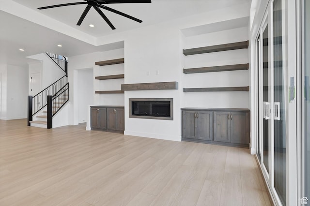3092 E 2110th St S, St George, UT 84790 - unfurnished living room featuring light wood-type flooring, a ceiling fan, stairs, recessed lighting, and a glass covered fireplace