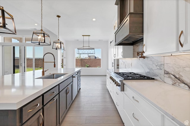 3092 E 2110th St S, St George, UT 84790 - kitchen with tasteful backsplash, stainless steel gas cooktop, recessed lighting, light wood-type flooring, and hanging light fixtures