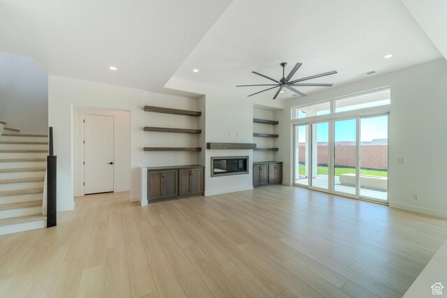 3092 E 2110th St S, St George, UT 84790 - unfurnished living room featuring stairs, ceiling fan, light wood-style flooring, a glass covered fireplace, and recessed lighting