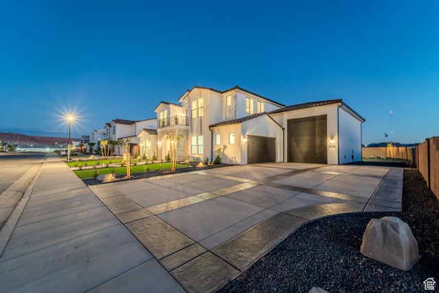 3092 E 2110th St S, St George, UT 84790 - view of front of house featuring a garage, concrete driveway, stucco siding, and a tile roof