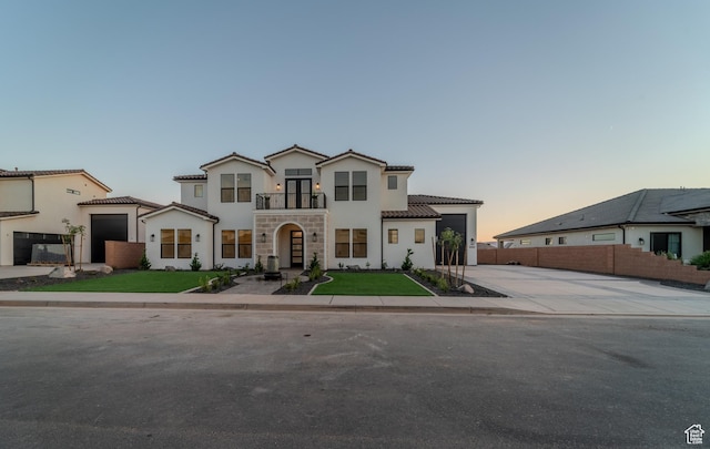 3092 E 2110th St S, St George, UT 84790 - mediterranean / spanish home featuring a balcony, a tile roof, stucco siding, and concrete driveway