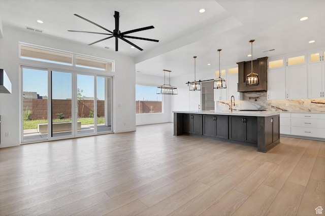3092 E 2110th St S, St George, UT 84790 - kitchen with light countertops, a chandelier, a large island, a ceiling fan, and light wood finished floors