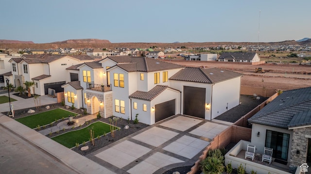 3092 E 2110th St S, St George, UT 84790 - mediterranean / spanish home featuring a balcony, stucco siding, driveway, a tile roof, and a residential view