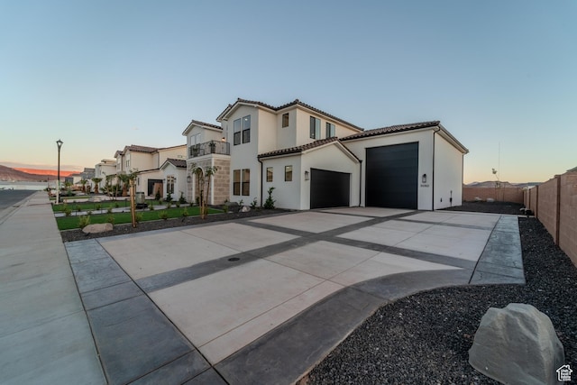 3092 E 2110th St S, St George, UT 84790 - view of front of property with concrete driveway, a tile roof, an attached garage, stucco siding, and a balcony