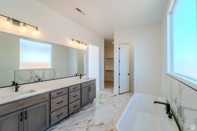 3092 E 2110th St S, St George, UT 84790 - full bath with double vanity, a freestanding bath, marble finish floors, and decorative backsplash
