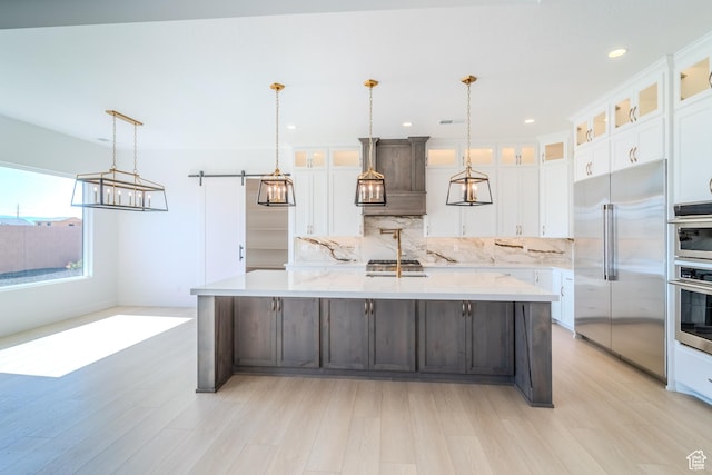 3092 E 2110th St S, St George, UT 84790 - kitchen featuring built in fridge, light wood-type flooring, a large island, tasteful backsplash, and white cabinetry