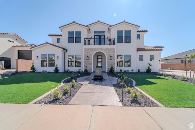 3092 E 2110th St S, St George, UT 84790 - mediterranean / spanish house featuring a balcony, a front yard, stucco siding, and a tile roof
