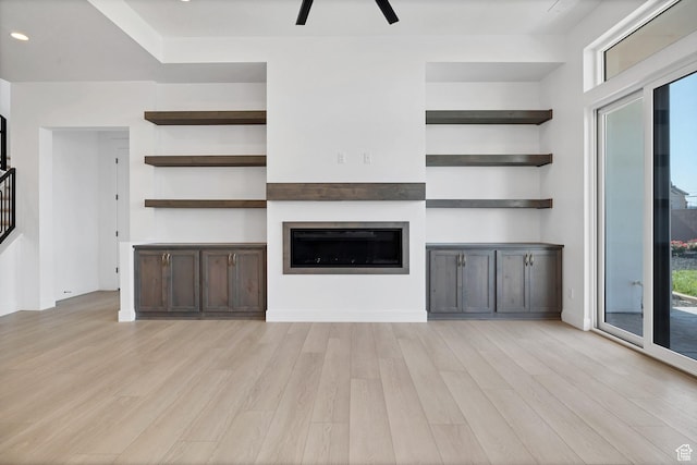 3092 E 2110th St S, St George, UT 84790 - unfurnished living room featuring light wood-type flooring, a fireplace, stairway, and recessed lighting