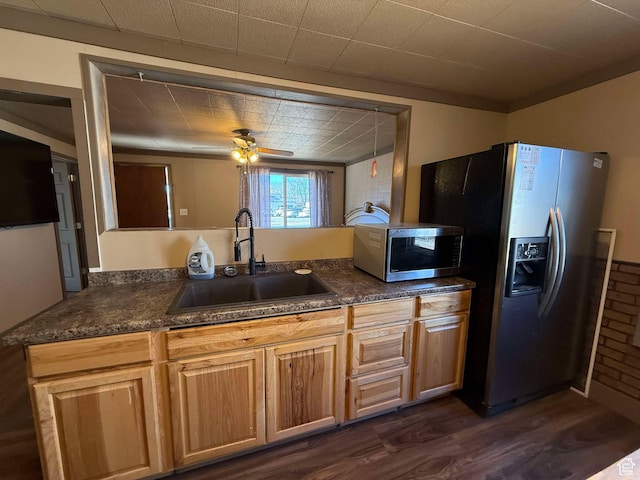 kitchen featuring appliances with stainless steel finishes, dark hardwood / wood-style floors, sink, ceiling fan, and kitchen peninsula