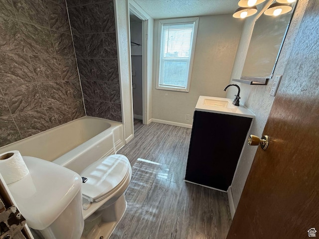 full bathroom with vanity, hardwood / wood-style floors, shower / bathing tub combination, and toilet