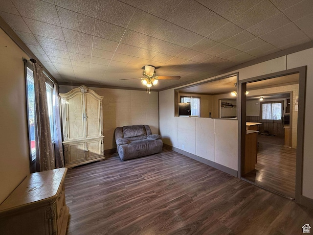 unfurnished room featuring dark wood-type flooring and ceiling fan