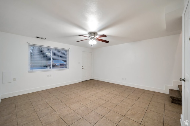 unfurnished room featuring light tile patterned floors and ceiling fan