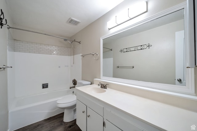 full bathroom with toilet, wood-type flooring, vanity, and tiled shower / bath combo