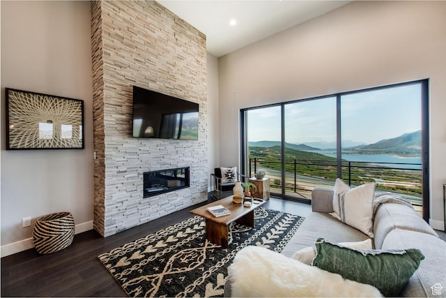 11785 N Apex Way Unit 60, Hideout, UT 84036 - living room featuring a towering ceiling, a stone fireplace, wood finished floors, and recessed lighting