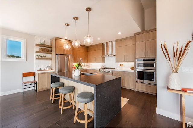 11785 N Apex Way Unit 60, Hideout, UT 84036 - kitchen with wall chimney exhaust hood, appliances with stainless steel finishes, tasteful backsplash, a kitchen bar, and dark wood-type flooring