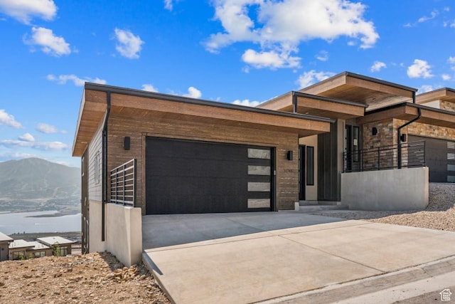 11785 N Apex Way Unit 60, Hideout, UT 84036 - modern home featuring a garage, concrete driveway, and a mountain view