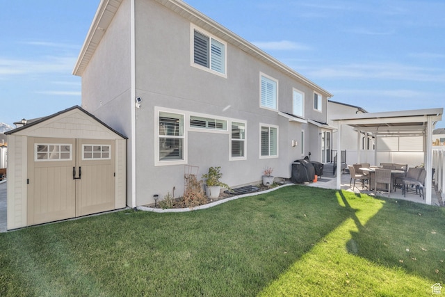 back of property featuring a yard, an outdoor hangout area, a storage unit, and a patio area