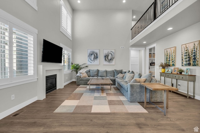 living room featuring hardwood / wood-style floors and a high ceiling