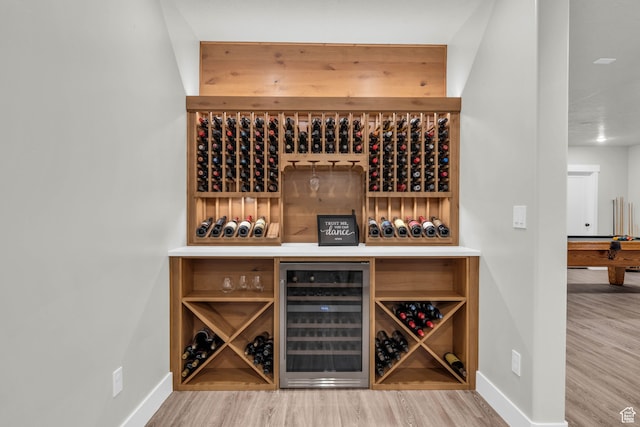 wine room featuring hardwood / wood-style floors and wine cooler