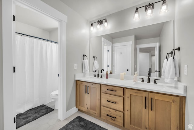 bathroom featuring tile patterned floors, vanity, and toilet