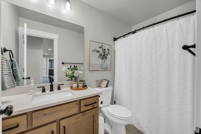 bathroom with tile patterned flooring, vanity, and toilet