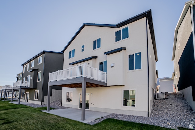 rear view of house featuring a yard, a patio, and central air condition unit