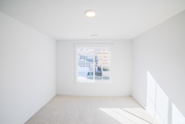 empty room featuring light carpet