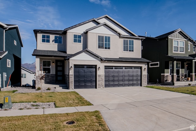 view of front of home with a garage and a front lawn