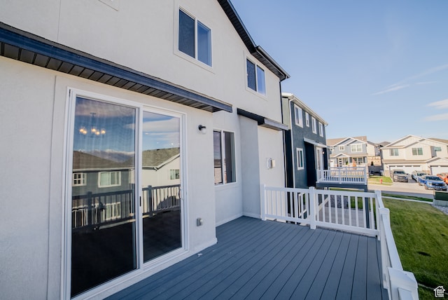 wooden terrace featuring a yard