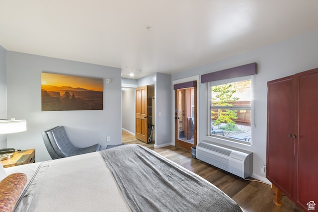 100 W 200 S Unit 103, Moab, UT 84532 - bedroom with a wall unit AC and dark hardwood / wood-style floors