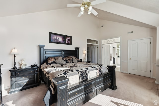 carpeted bedroom with ensuite bath, ceiling fan, and vaulted ceiling
