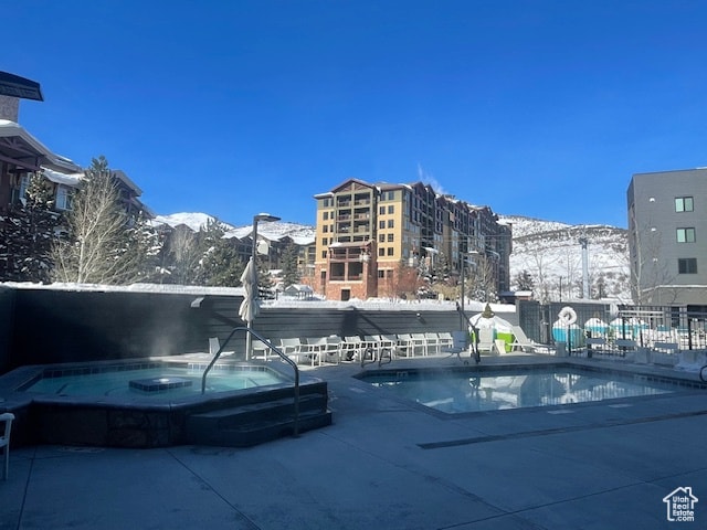 2670 W Canyons Resort Dr Unit 205, Park City, UT 84098 - snow covered pool featuring a mountain view and a hot tub