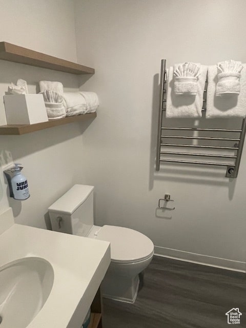 2670 W Canyons Resort Dr Unit 205, Park City, UT 84098 - bathroom with hardwood / wood-style flooring, toilet, radiator heating unit, and sink