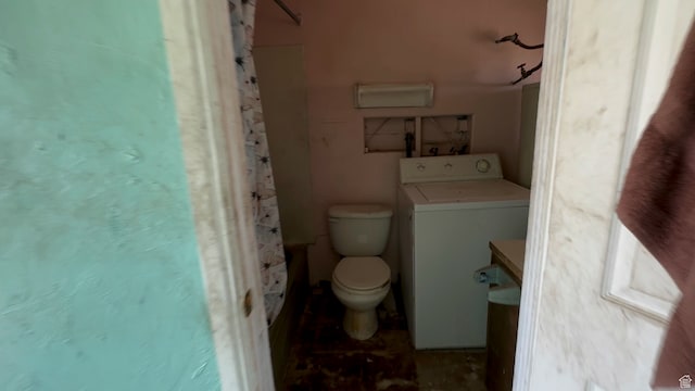 full bathroom featuring toilet, vanity, shower / tub combo, and washer / dryer